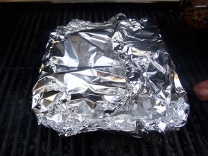 Sealedaluminum pouch on grill. Sealedaluminum pouch on grill.