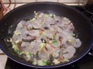 Shrimp, garlic and scallions in skillet.